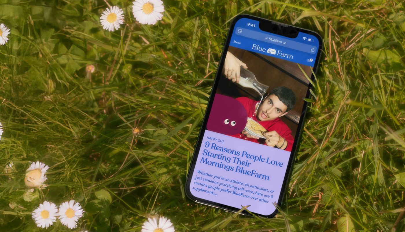 Blue Farm — the store on a phone, in the grass